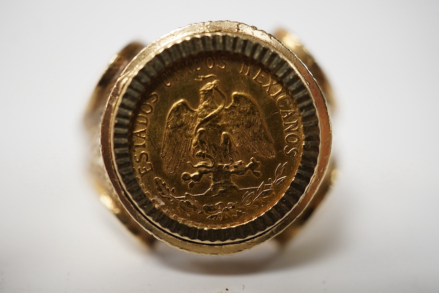 A 9ct gold ring set with a gold Mexican Two Peso coin, size R1/2, British hallmarks, gross weight approximately 9 grams. Condition - good, some scratches